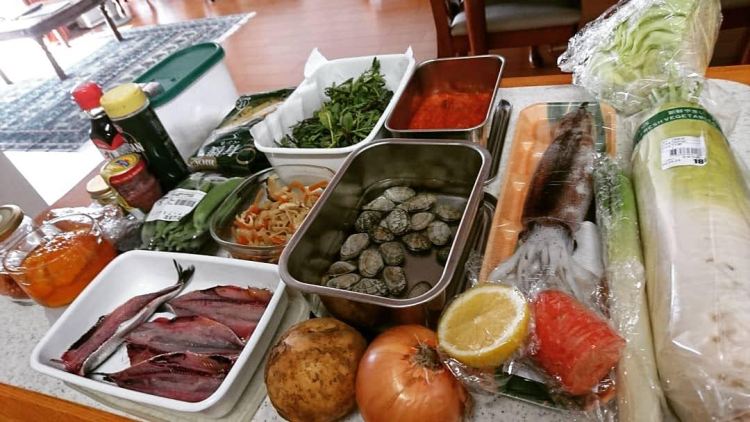 カウンターに魚や野菜、調味料などの食材が沢山並んでいます。